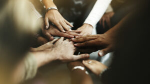 Closeup of diverse people joining their hands