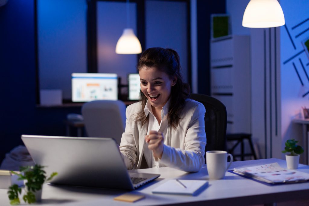 Business woman looking at professional laptop working at marketing graphs project