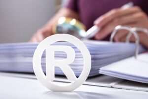 White Registered Trademark Sign Near Documents