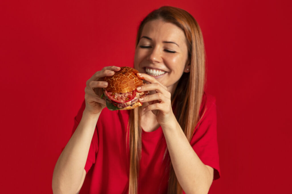 medium shot young woman eating burger